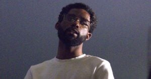Portrait of a man with glasses and a beard looking thoughtful.