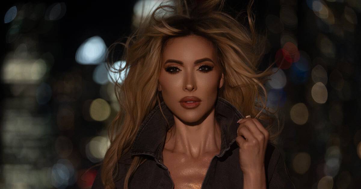 Kinetic portrait of a female artist in city nightlife, bold makeup and tousled hair.
